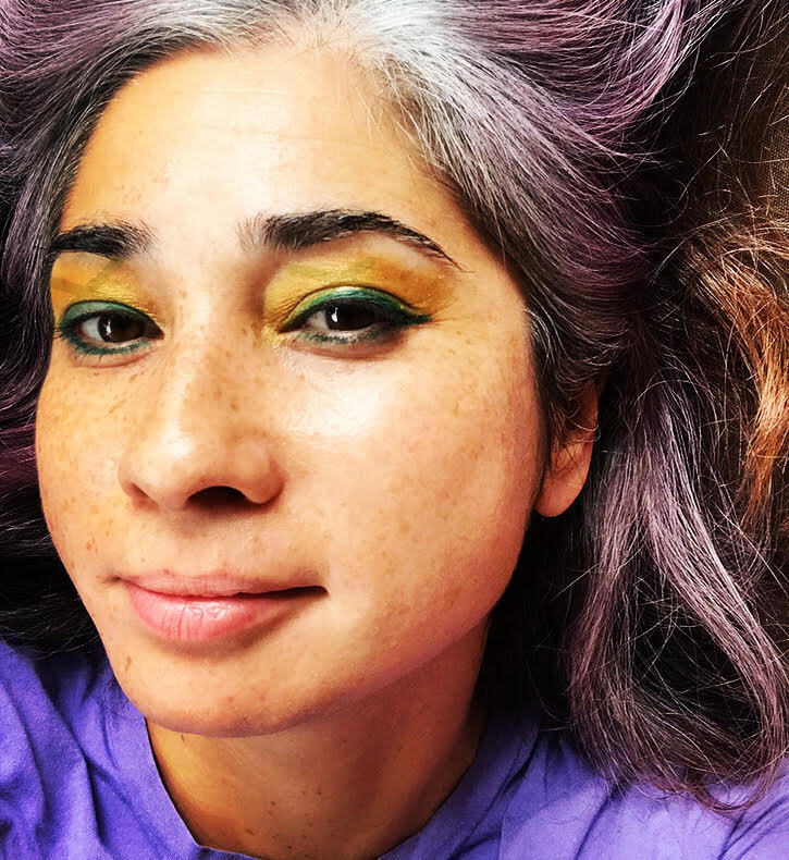 A close-up photo of a person wearing green eyeshadow.