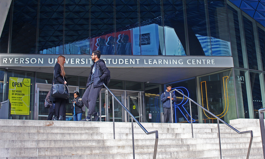 students stand outside of the steps of the Sheldon and Tracy Student Learning Centre