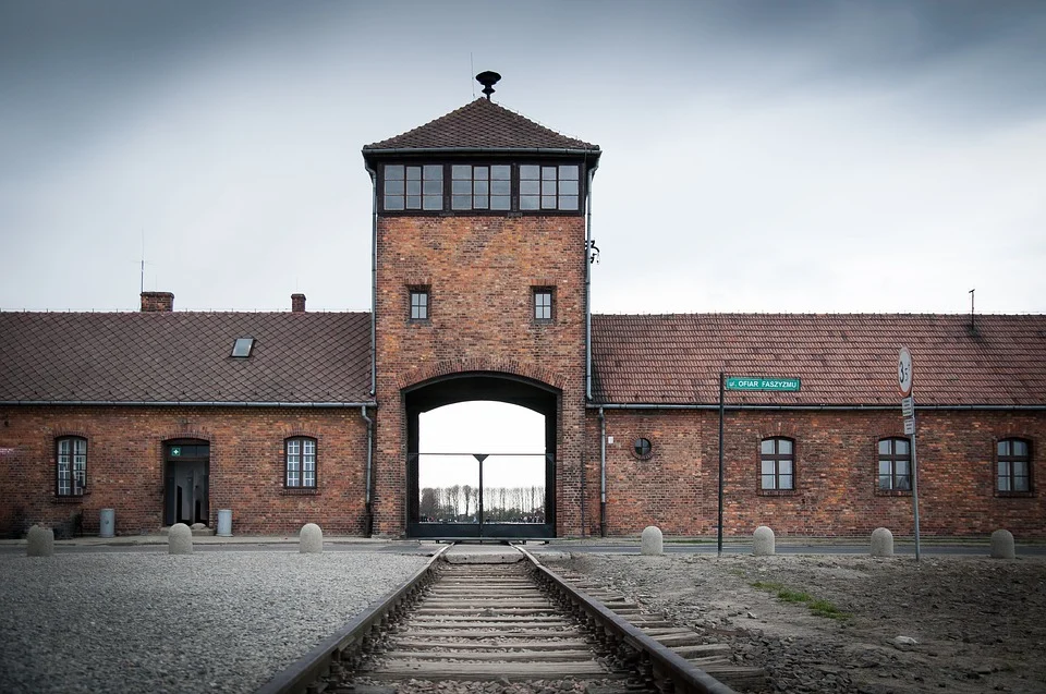 a railroad track leads to the inside of a door to the Auschwitz concentration camp