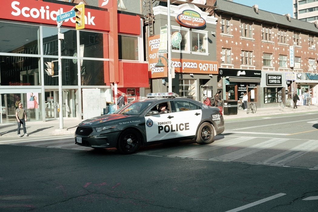 a Toronto police vehicle on the streets in front of shops downtown like PizzaPizza and Scotiabank
