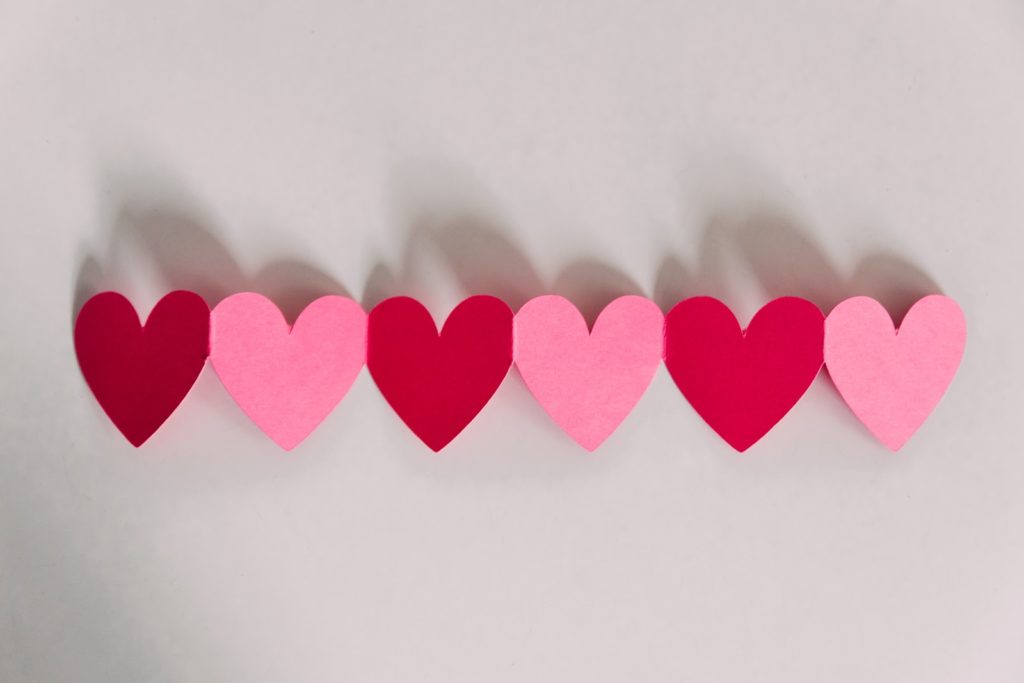 six pink and red hearts displayed by alternating colours on a white background