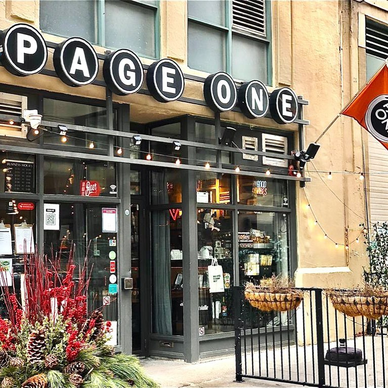 the storefront of the Page One Cafe across from Ryerson University with the business's name written on singular circular boards