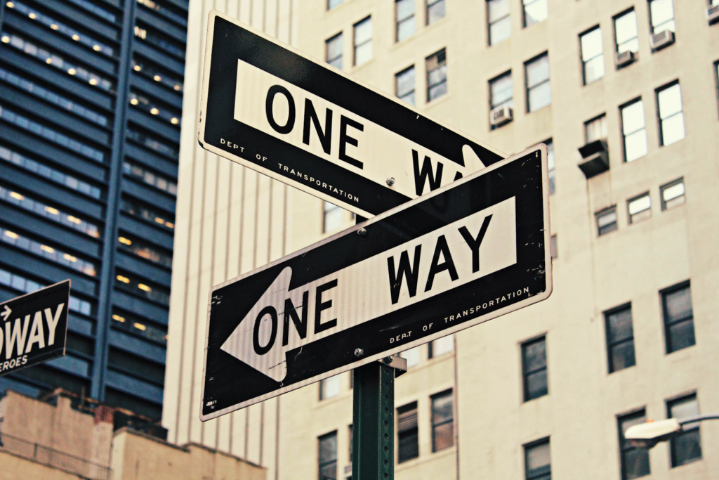 a street sign that says "One Way" on it 