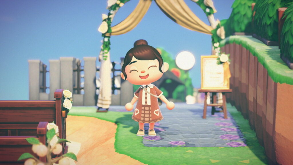 A screenshot from Animal Crossing: New Horizons featuring a smiling character in a backyard.