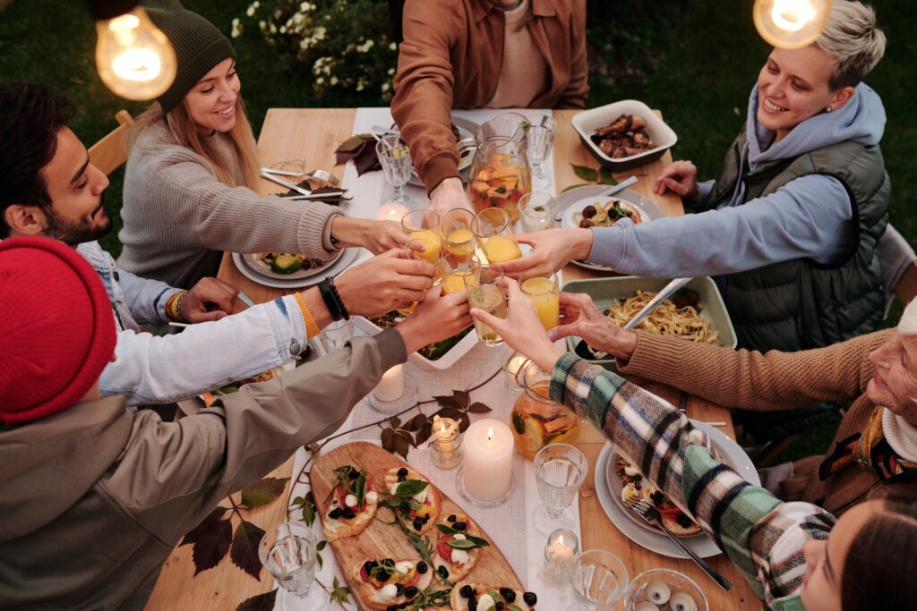 People toasting around a Thanksgiving spread