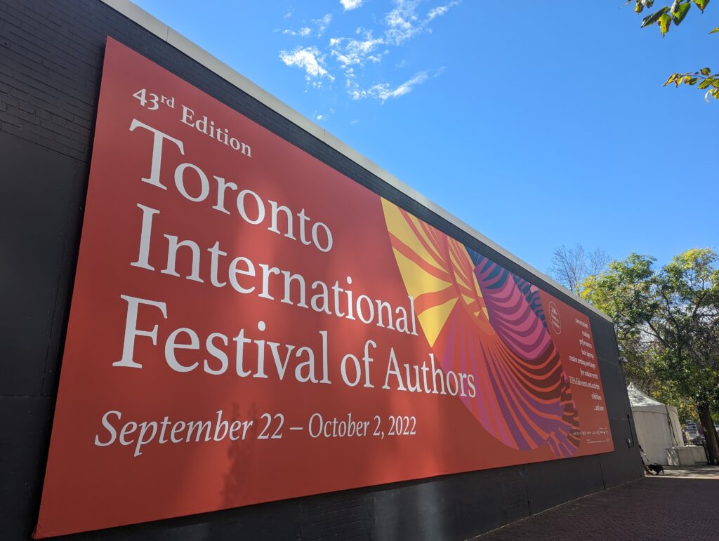 Large, red sign with TIFA written across hanging from building