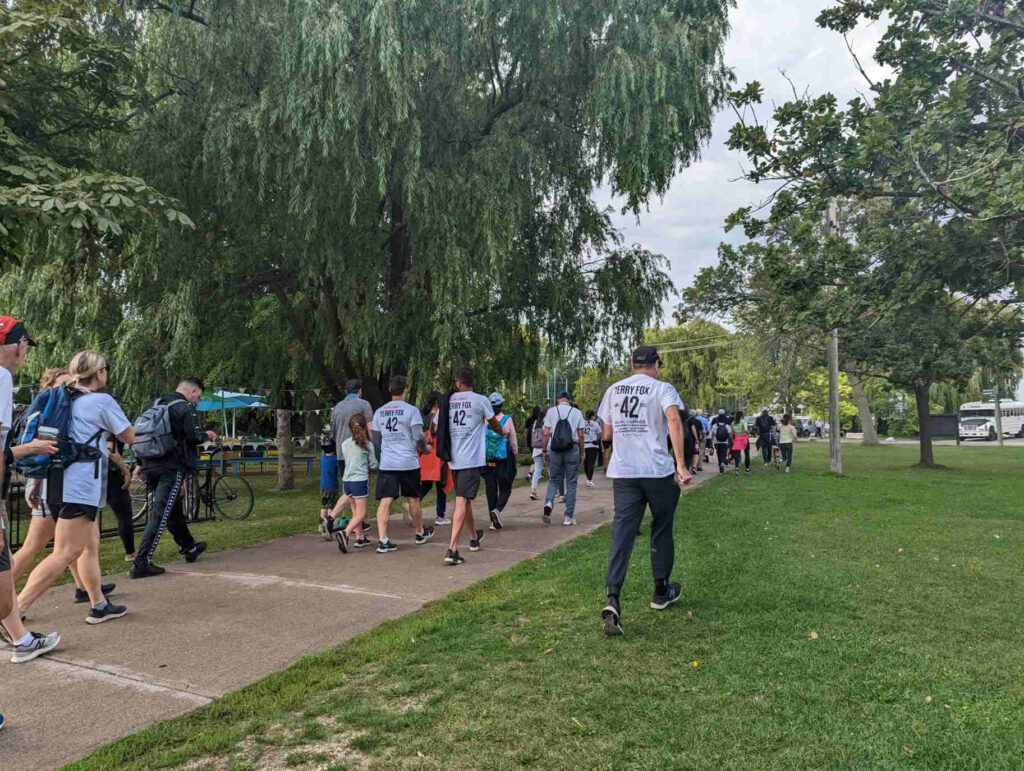 Ward’s Island Terry Fox run participants walking on a cement path.