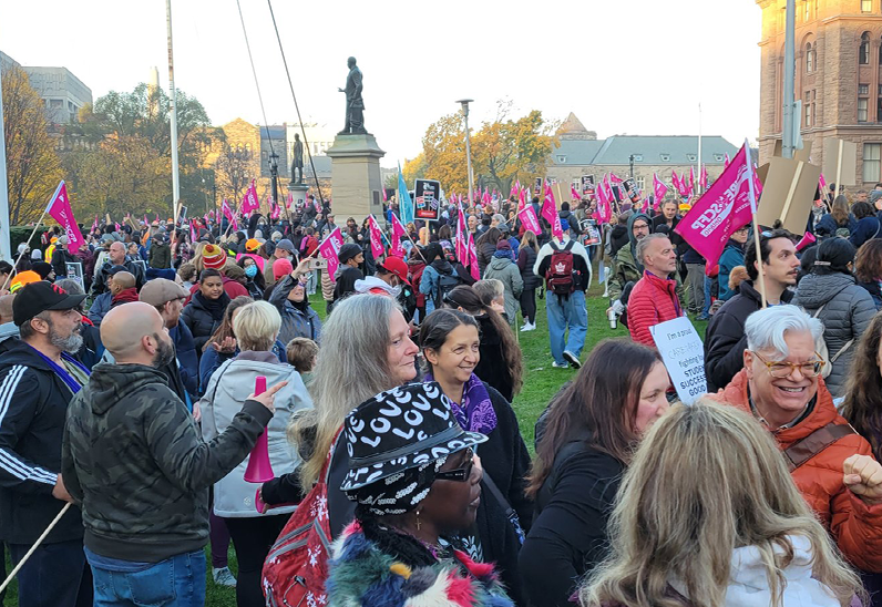 Protesters stand outside of Queen's Park