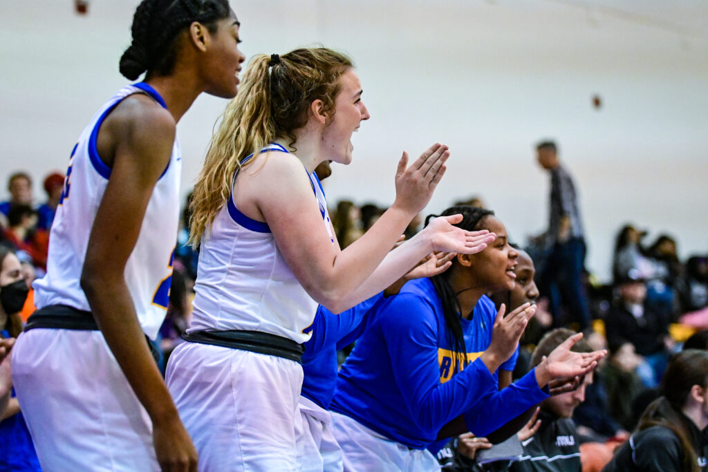 Farwell and teammates clapping and cheering from team bench