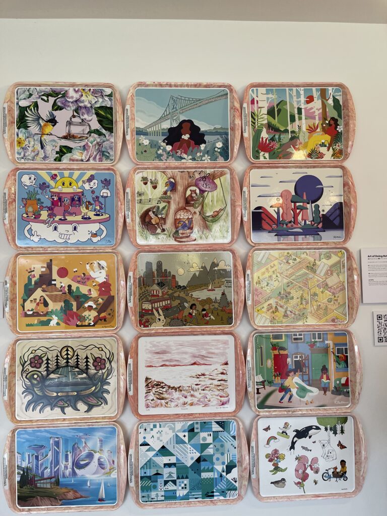 Image framed to include fifteen unique lunch trays. Each tray is detailed with a different artists illustrations at its centre.