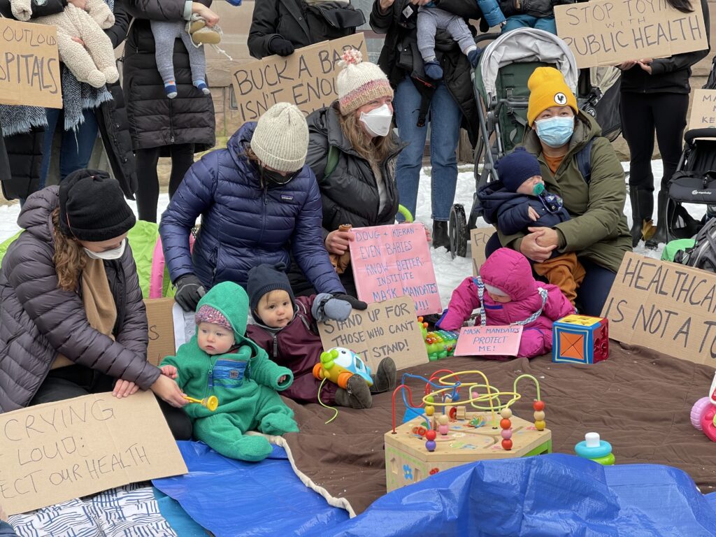 Image displaying a play mat created by parent protestors for their babies near Queen's Park in Toronto.