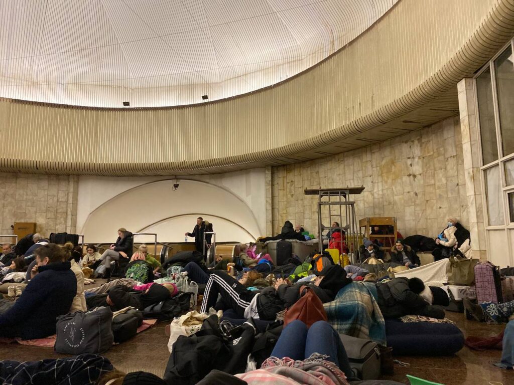 People hiding with luggages in an underground space in Kyiv, Ukraine to be safe from the war.