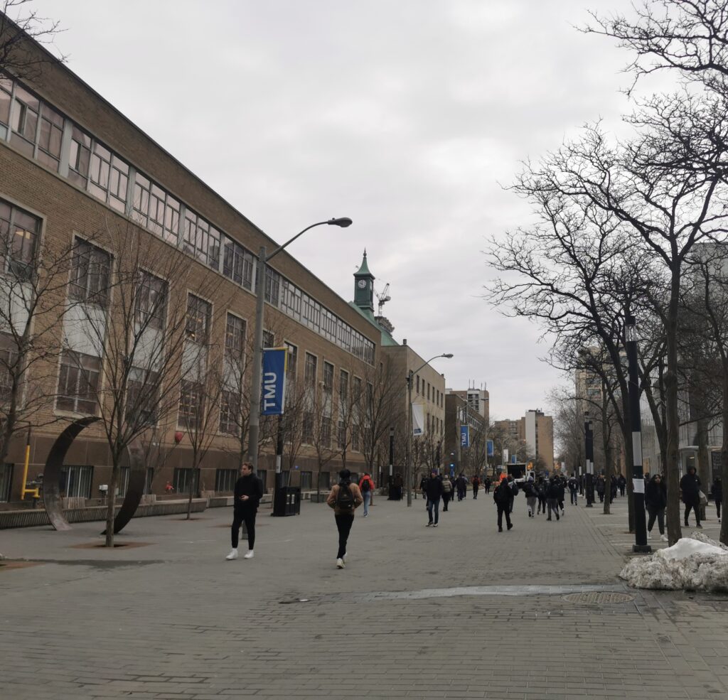 Photo of campus looking down Gould St. with students walking.