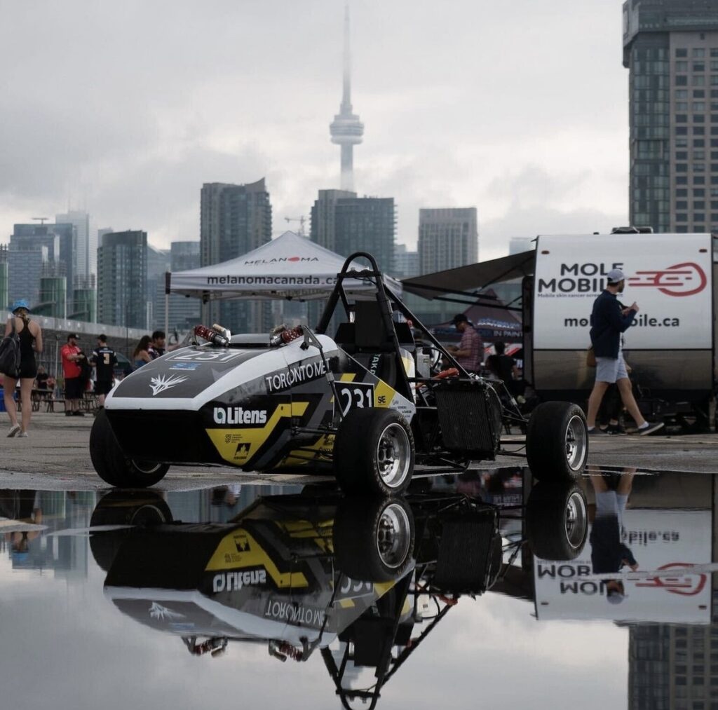 Toronto Met Formula Racing's 2022 racecar with Toronto's skyline in the background.