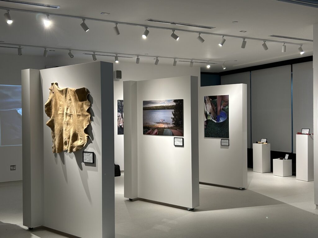 Exhibit overview (left to right) tanned hide, view of the tanning location, and soaking the hide after graining.