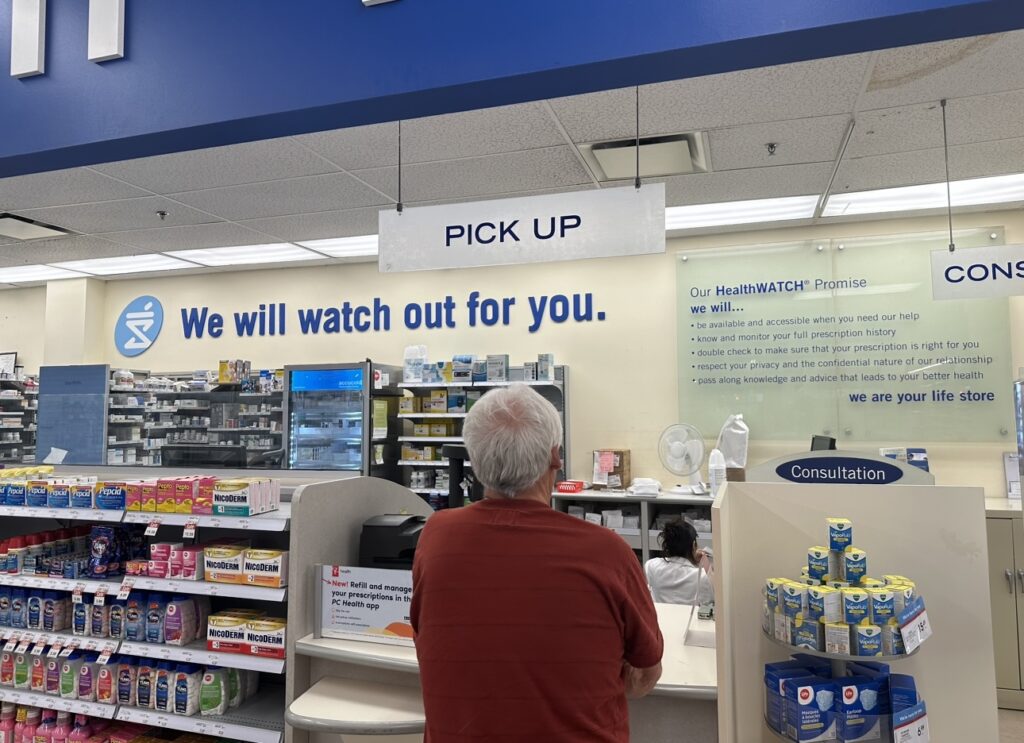 Man standing at a pharmacy
