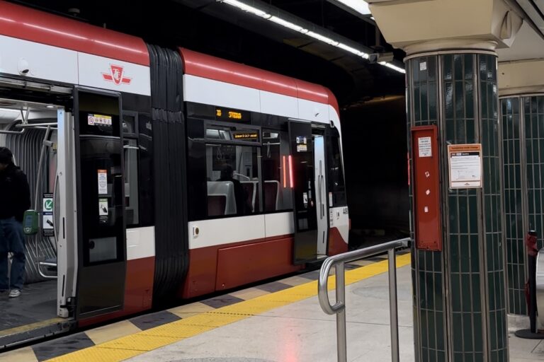 An image of a red and white subway cart that operates with the Toronto Transit Commission (TTC).