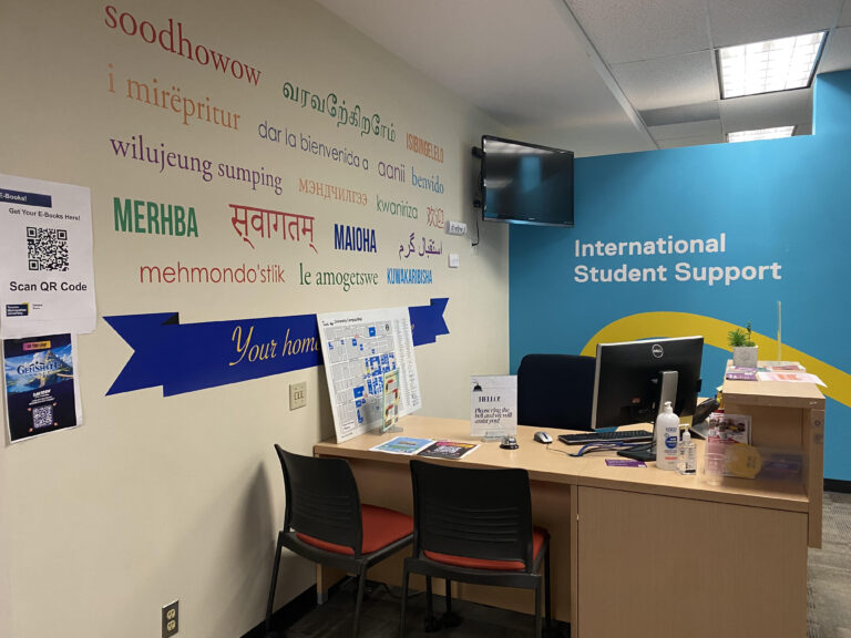 A photo of the International student support office at Toronto Metropolitan University showing a wall with words in different languages.