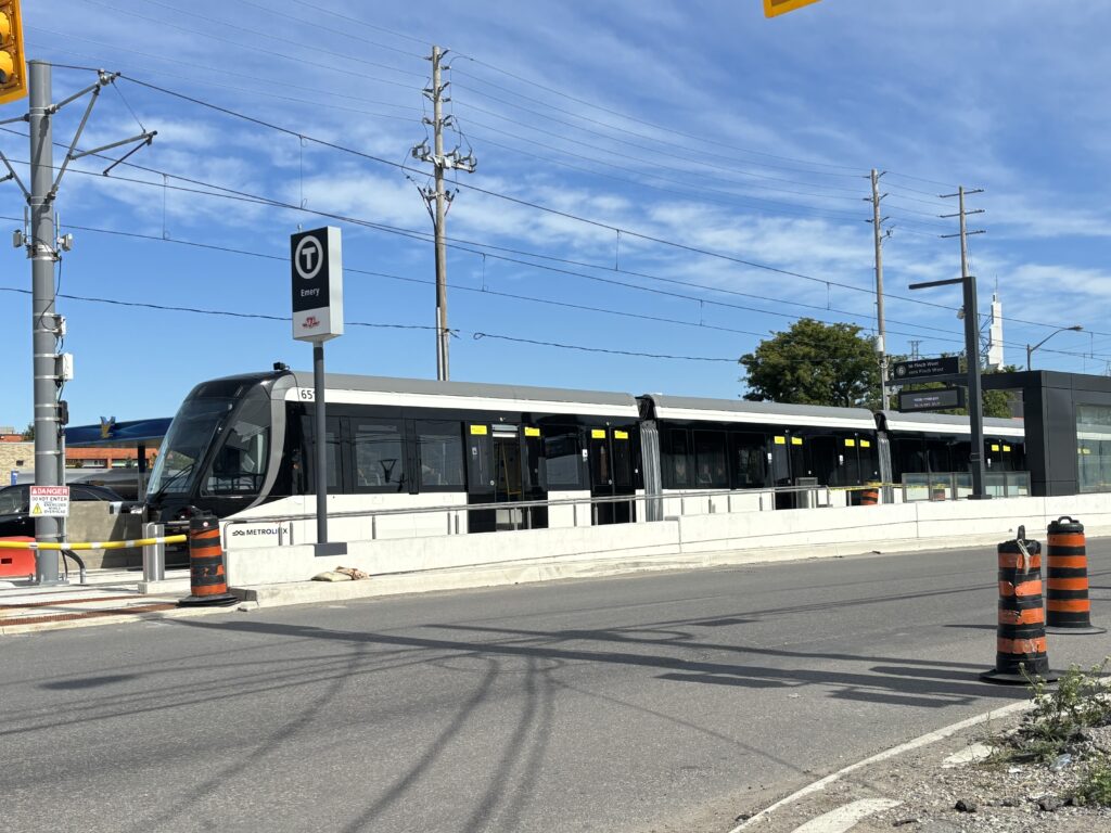 Finch West LRT stopped at a stoplight at Emery station