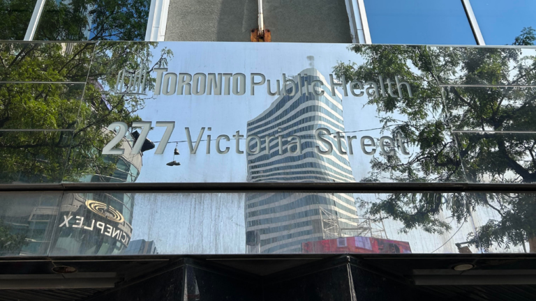 Reflective metal sign that reads 'Toronto Public Health' and '277 Victoria Street' below.