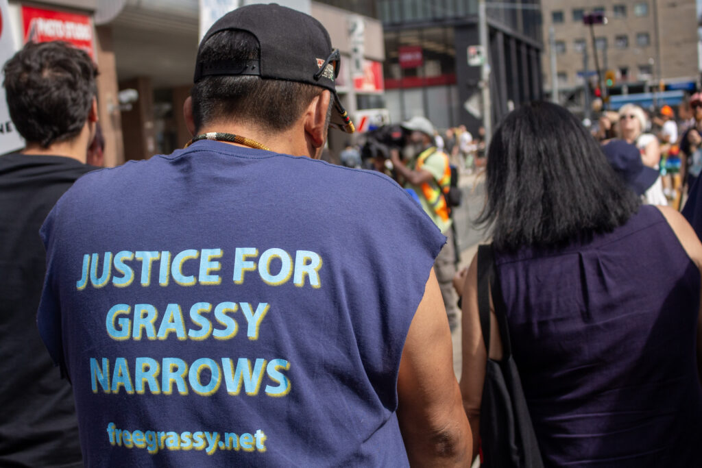 "Justice for Grassy Narrows" Written on the back of a protestor's shirt