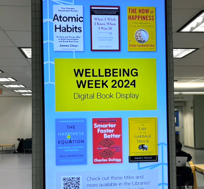 Photo of large screen displaying a variety of self-help and mental-health based books.