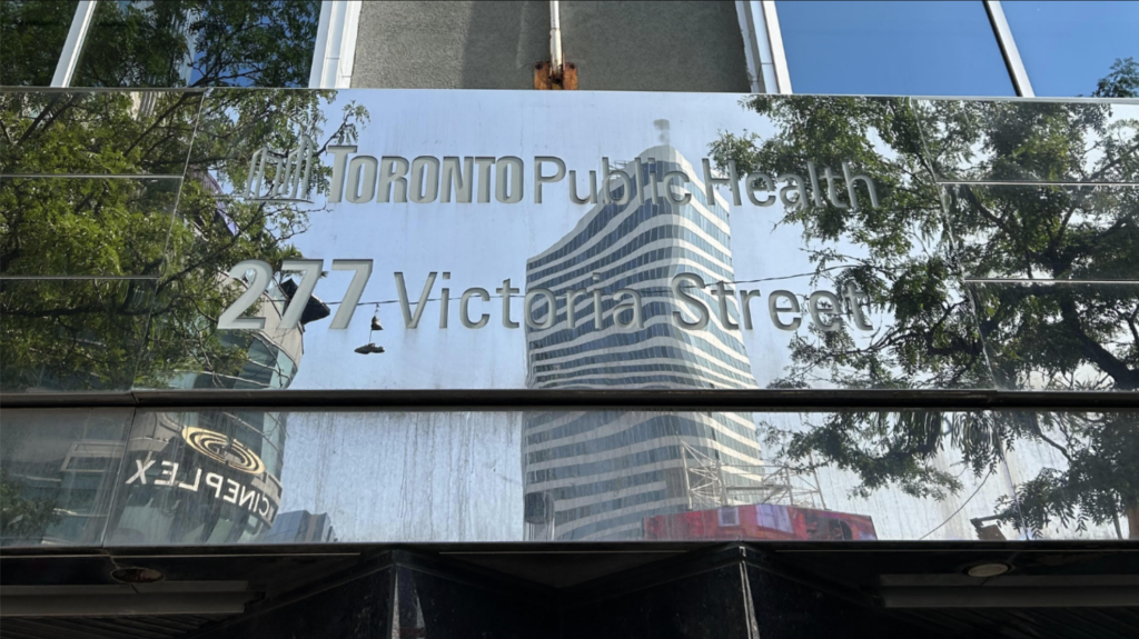 Side of building with a mirrored sign.