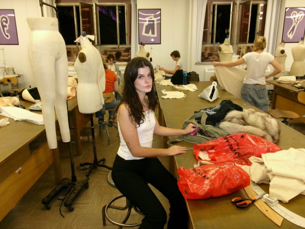 A woman sitting in a sewing studio