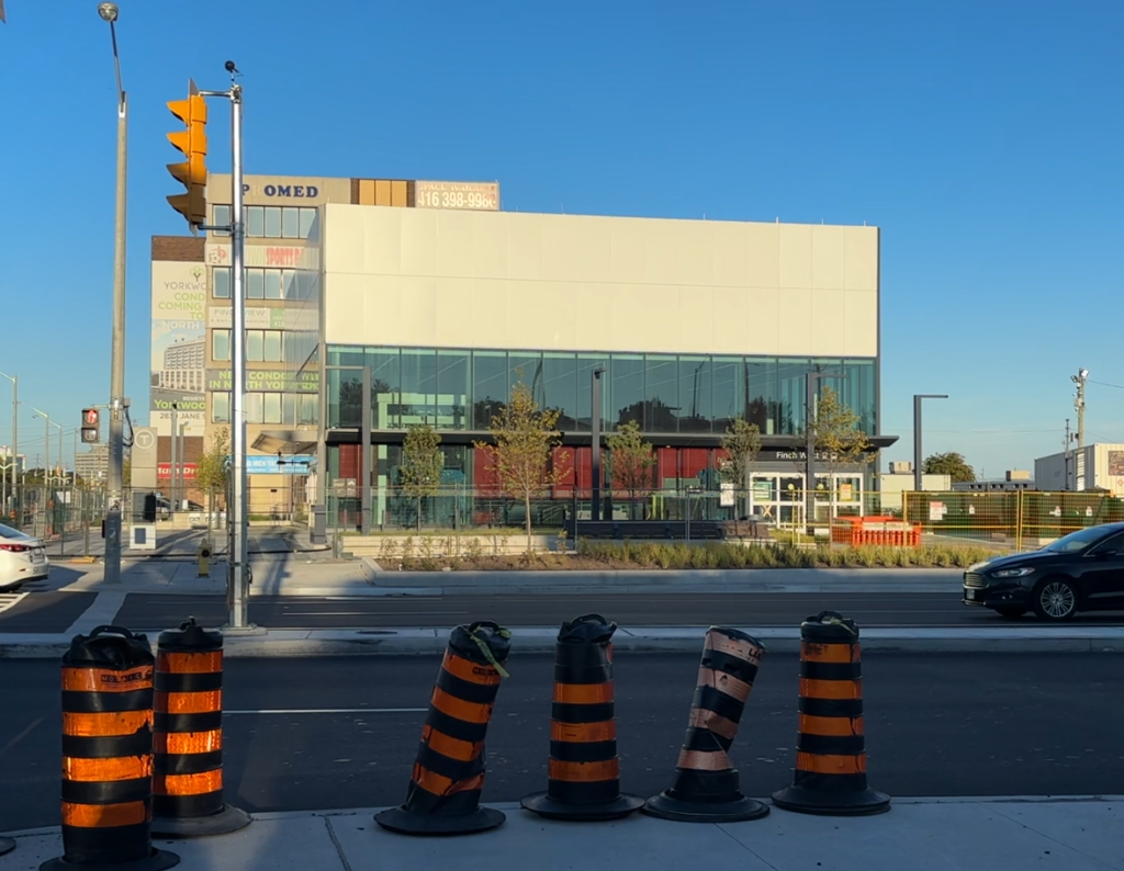 Train station building with black traffic cones