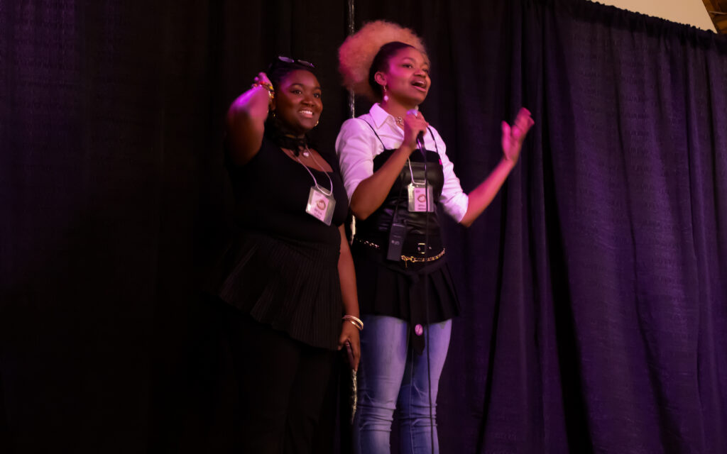 Two women giving a speech on stage