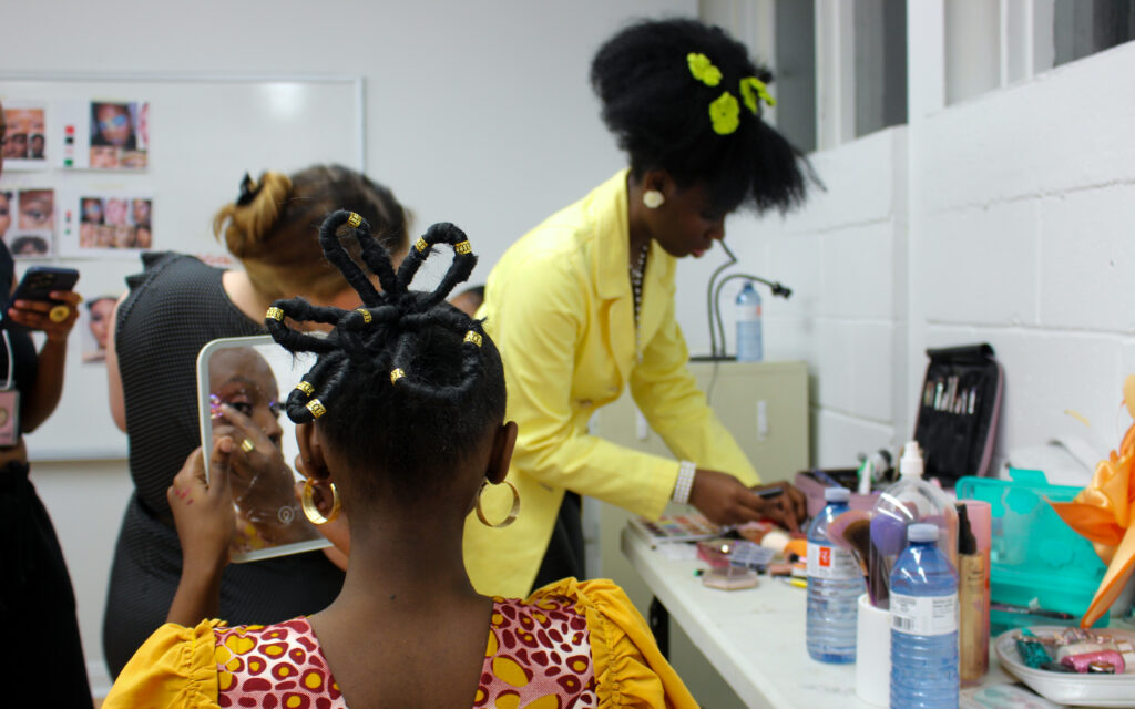 A woman checks her makeup in the mirror