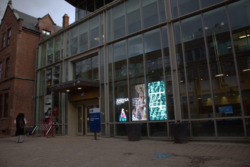 The outer view of a building with floor-to-ceiling glass walls. 