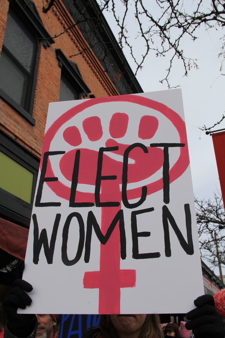 Pink and white poster with fist