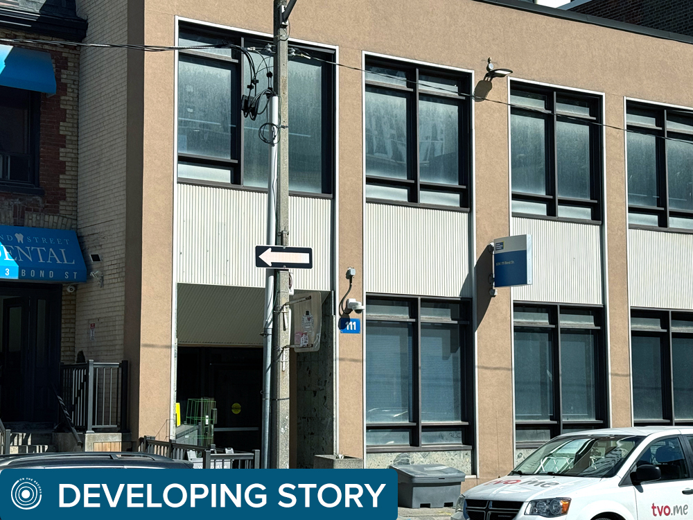 A photo of the outside of a building on Bond St with a blue banner at the bottom that says developing story.