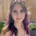 A photo of a woman with purple hair