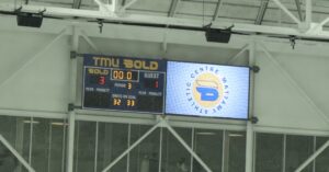 A photo of the scoreboard showing the final score, 3–1, shots on goal, 32-33, and the final time on the clock, 0 minutes, after TMU’s homecoming hockey game.