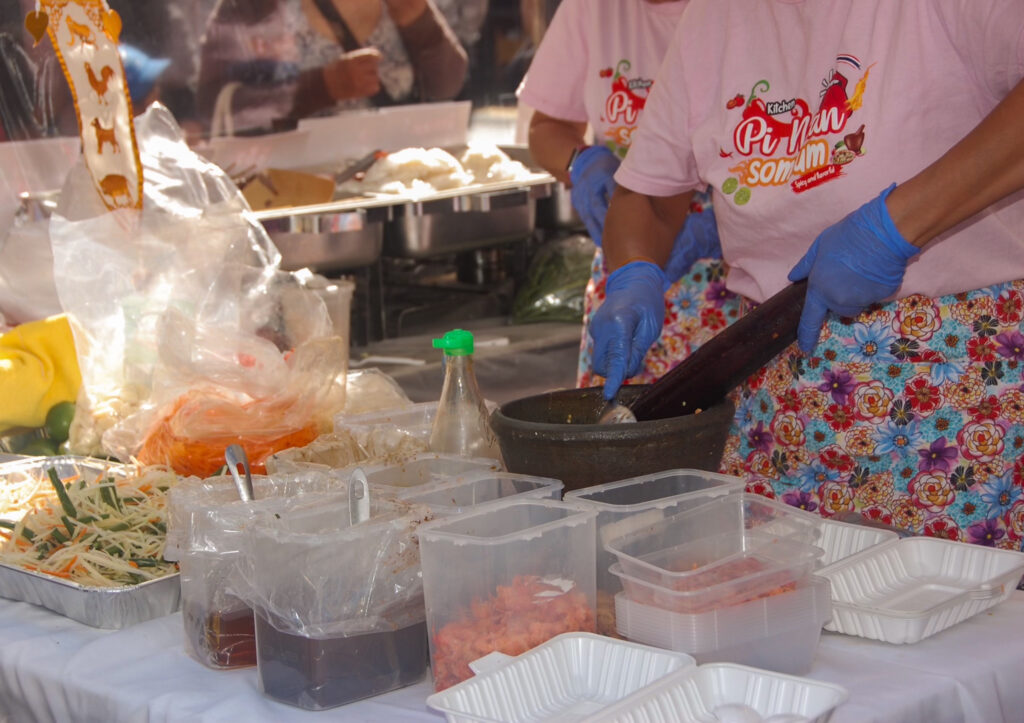 This is a photo of a woman's hands preparing food with bowls in front of her.