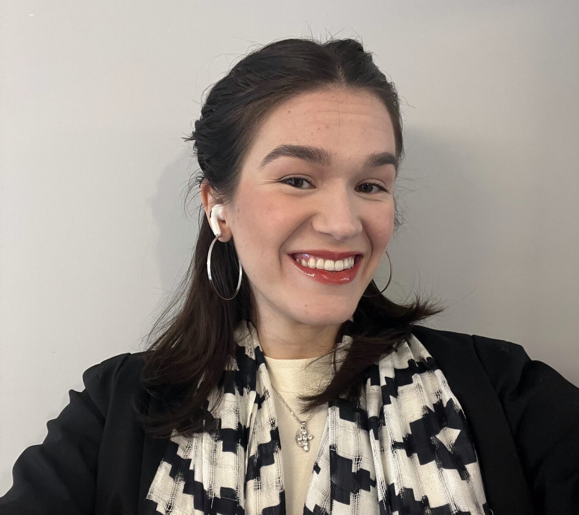 A photo of a woman with long brown hair smiling.