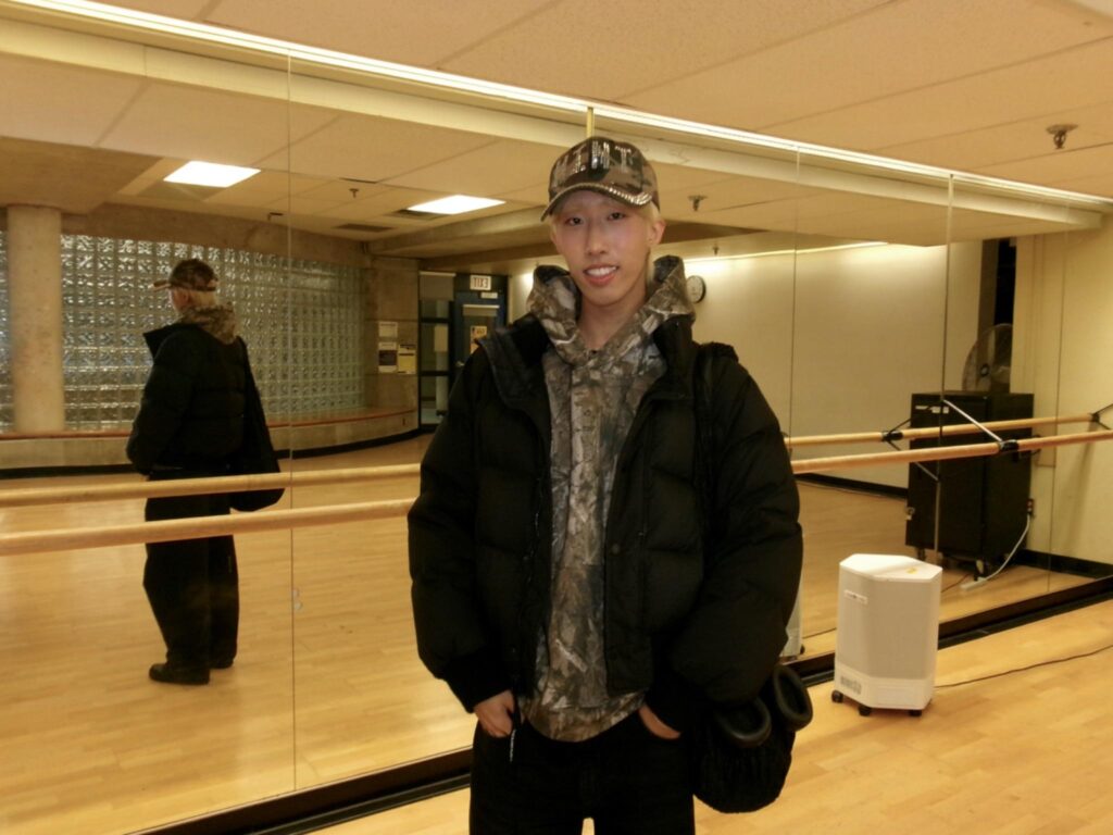 A man smiling at the camera in dance studio