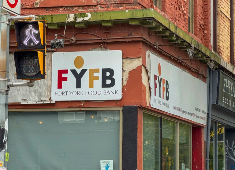 A photo of the outside of the Fort York Food Bank. The sign on the outside of the building reads Fort York Food Bank.