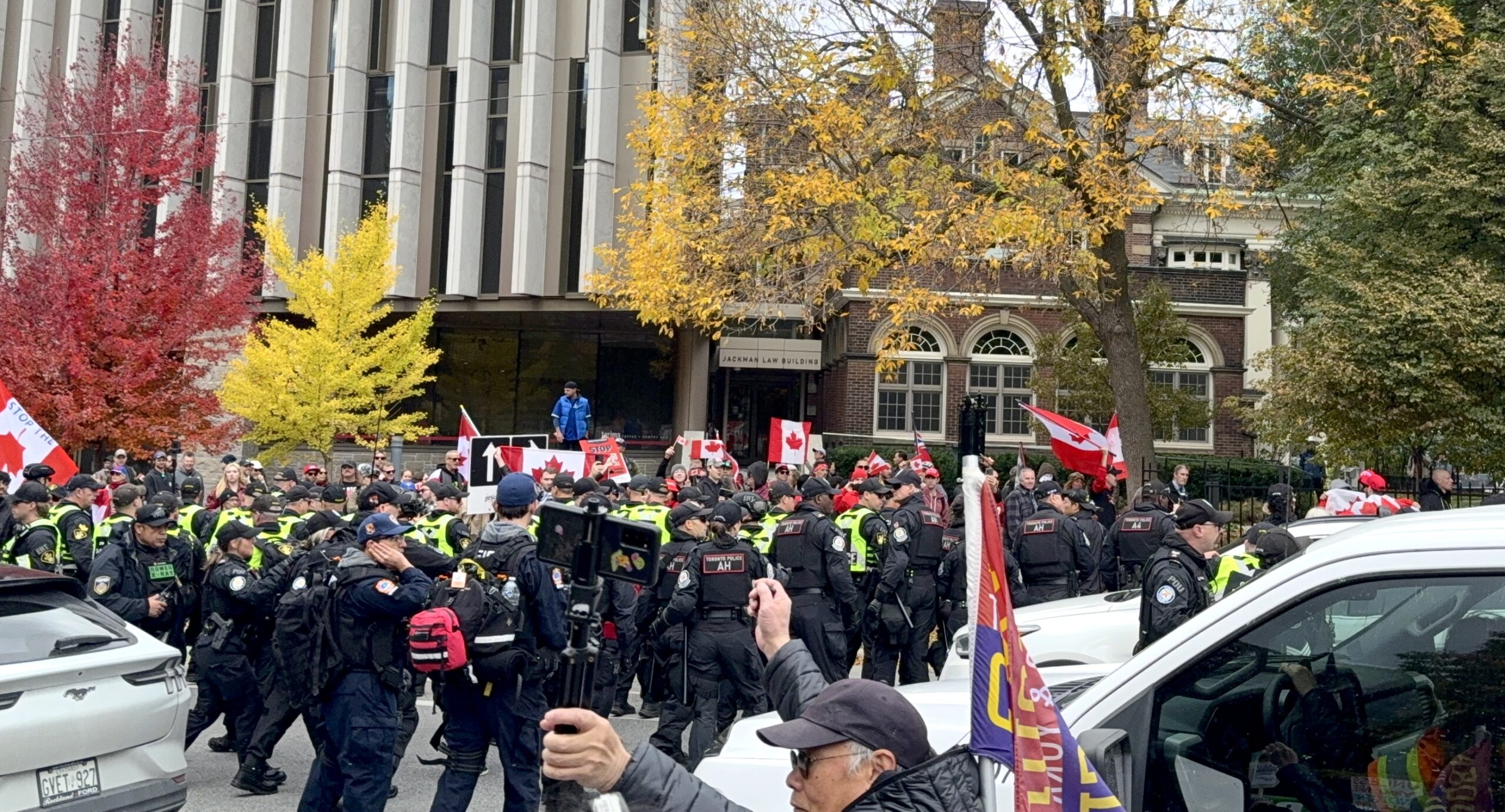 Police officers standing on the street to separate Canada First supporters and counter-protesters