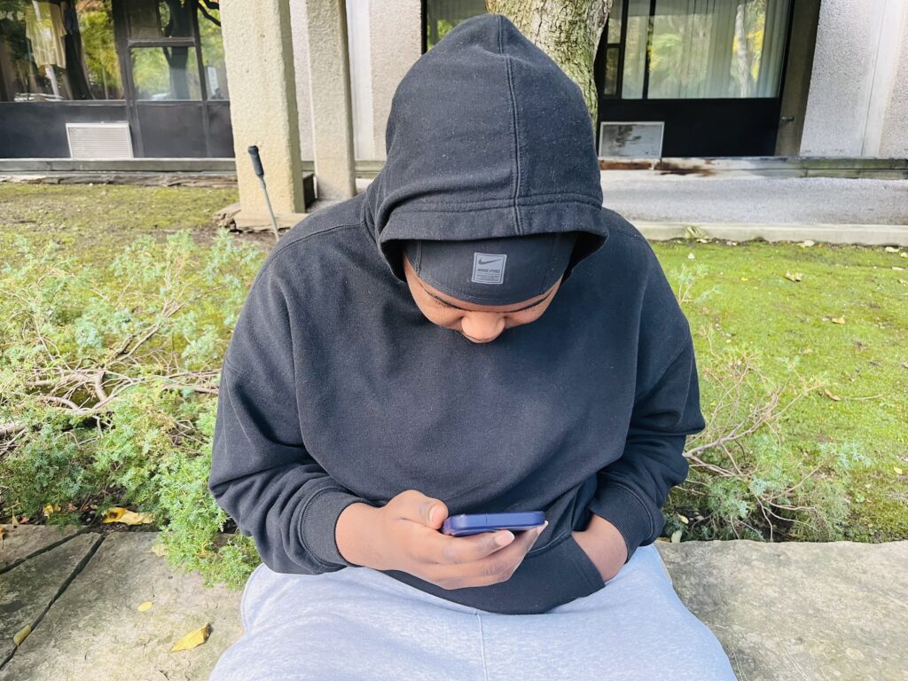 Teenage boy scrolls through social media, showing how misogynistic content is consumed online.(OTR/Praise Ditep)