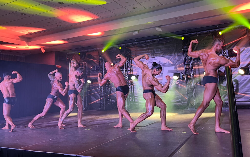Male athletes showcasing their physique during the event
