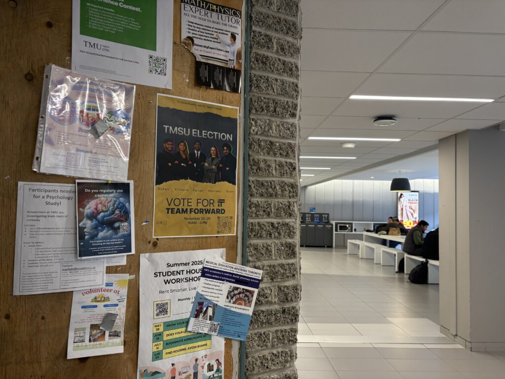 Election poster on bulletin board outside cafeteria.