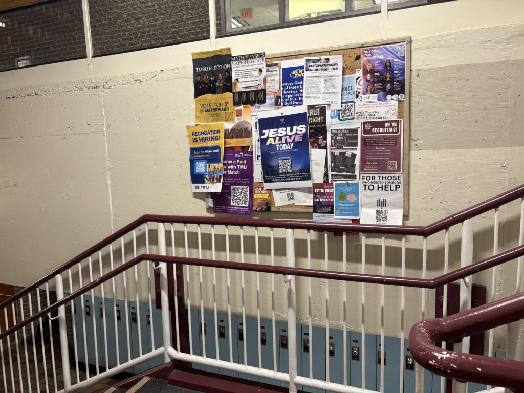 bulletin board on the wall in stairwell