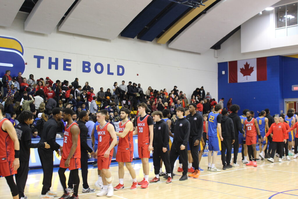 Basketball players shake hands with each other after a game.