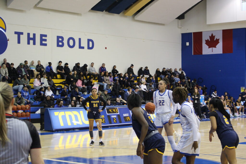A basketball player prepares to take a free throw during a game.