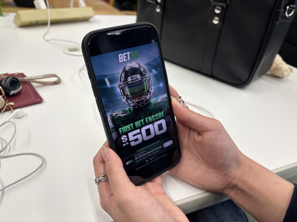 Advertisement for BET99, a sports betting app is seen on a cellphone
