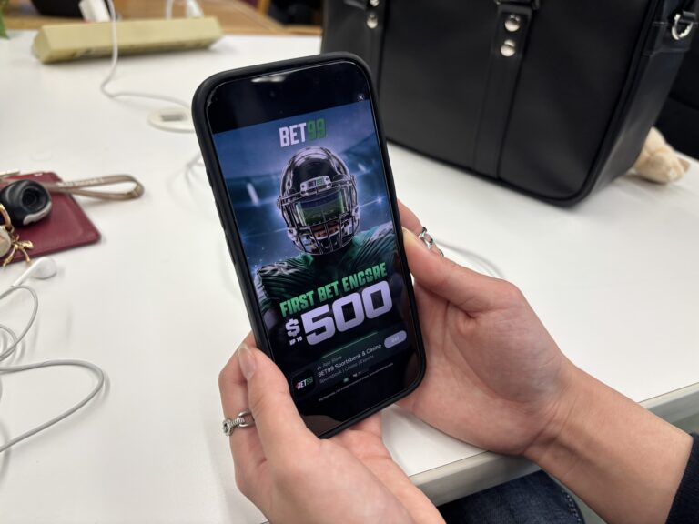 Advertisement for BET99, a sports betting app is seen on a cellphone