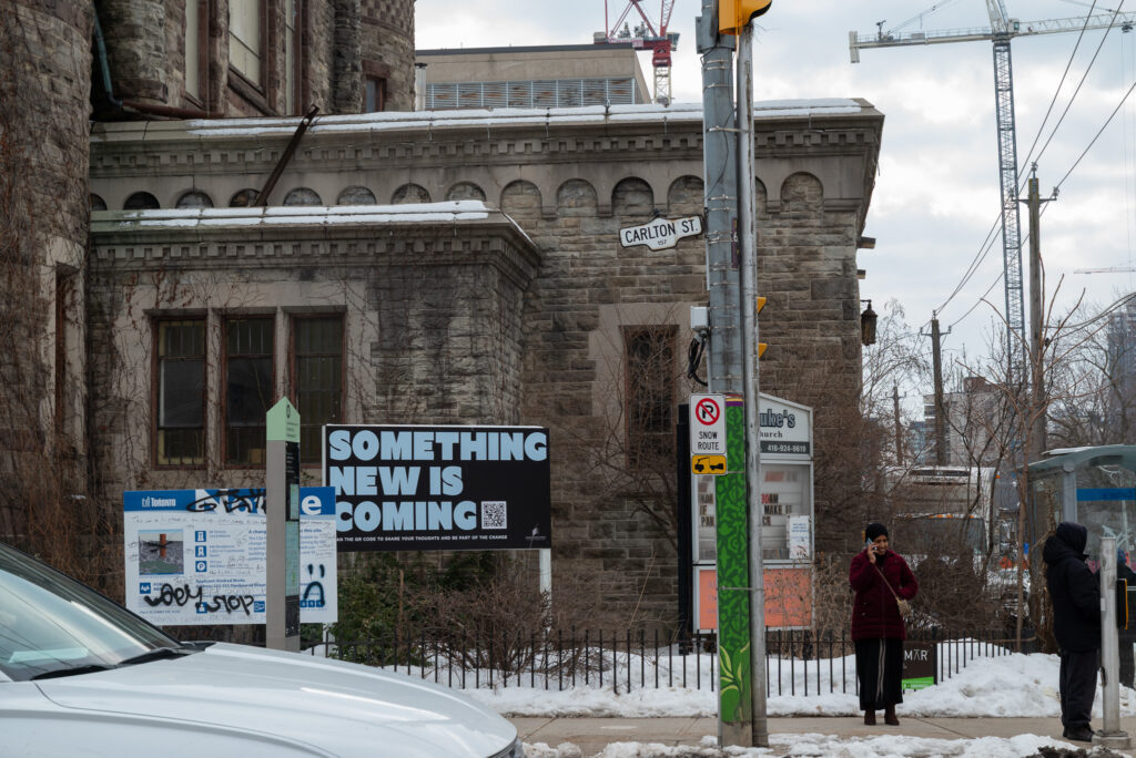 The exterior of a church with various signs posted in front.